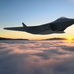 A simulation of the GCAP fighter jet flying at sunrise